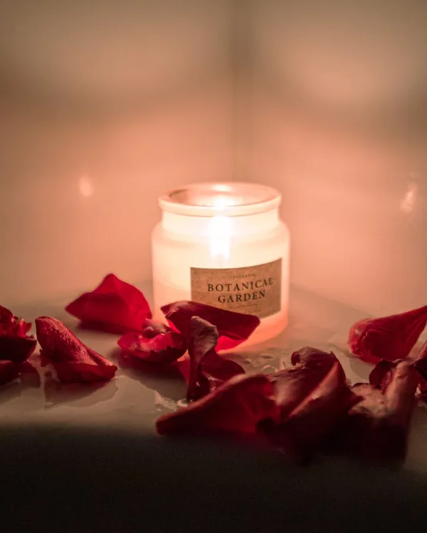 Romantic candle with rose petals